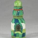Small green striped bottle with marble top. The bottle and the marble were both found washed up along the beach.