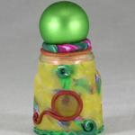 Small green and yellow Genie bottle. 