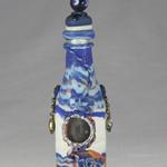 blue swirled Genie bottle adorned by glass bead dangles on the sides and a beaded top