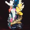 Coral and glass on blue glass vase with polymer clay corals, leopard shark, starfish, crabs and other sculpted crustaceans.
